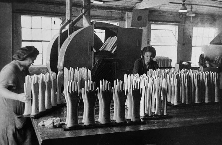 Produktion von Gummihandschuhen: Verwendet wurden dafür Porzellanformen verschiedener Größen (Aufnahme um 1955). Quelle: Gummi ‒ Die Elastische Faszination