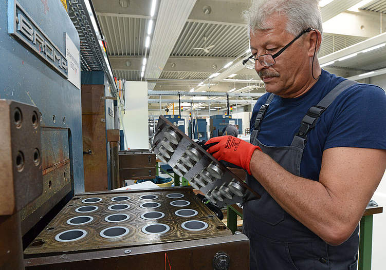 Nicht alles geht automatisiert: Mitarbeiter Zbigniew Kocjan entformt die fertigen Gummidichtungen. Foto: Wiegand Sturm